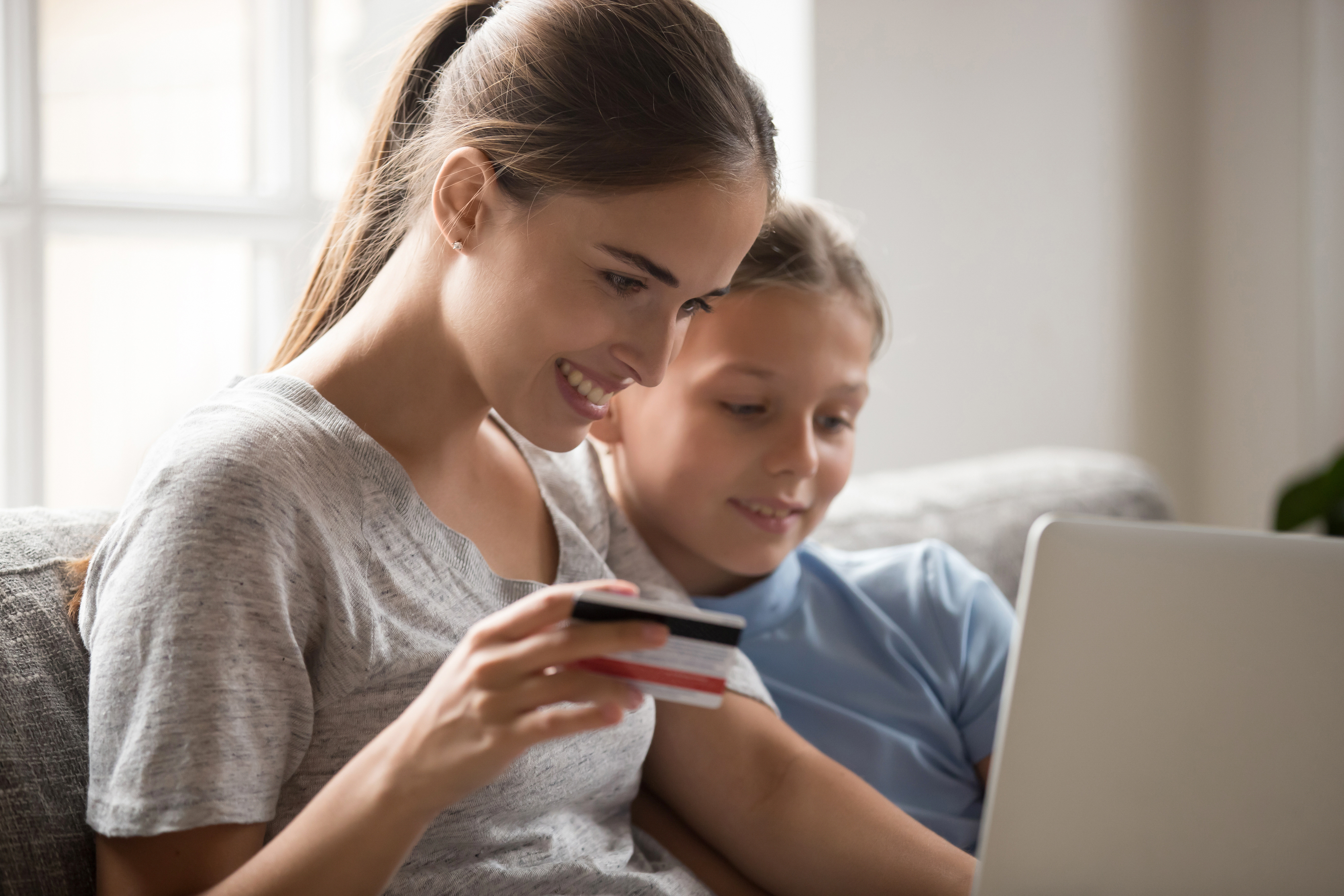 Mom and daughter checking mobile banking.